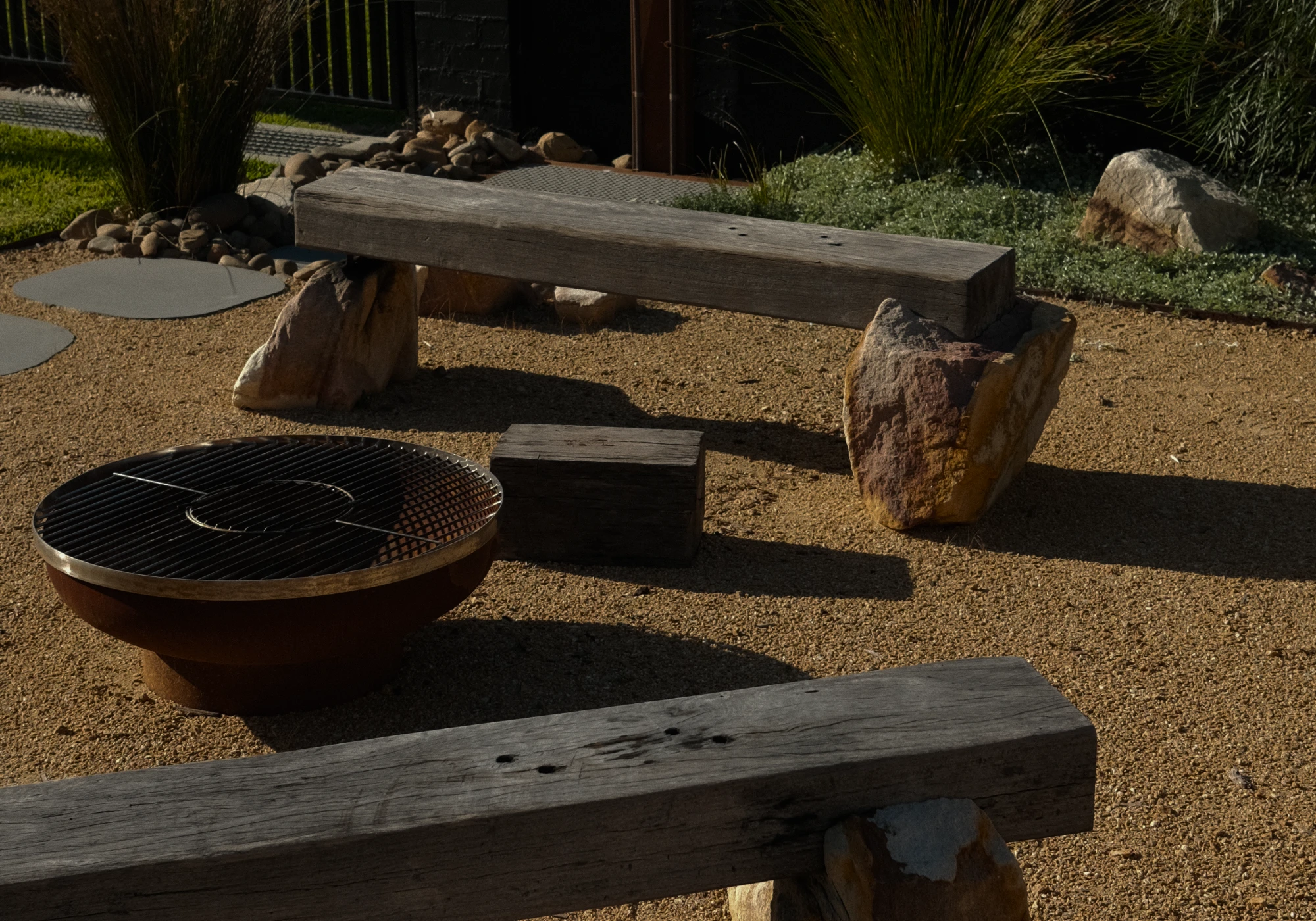 Fire pit area with recycled timber benches and sandstone